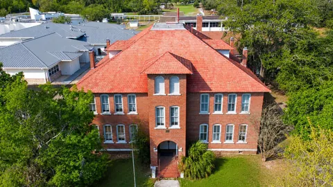 Aerial view of the historic brick school building inspected in Fort White, Florida